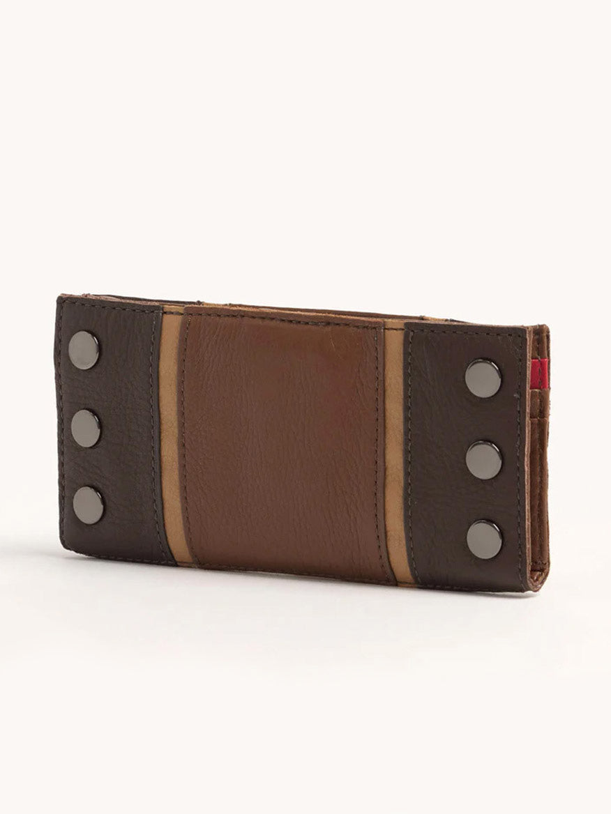 The Hammitt Los Angeles 110 North Wallet in Orchestra Brown, crafted from pebbled leather, features dark accents and four metal studs on each side, seamlessly combining style with functionality.