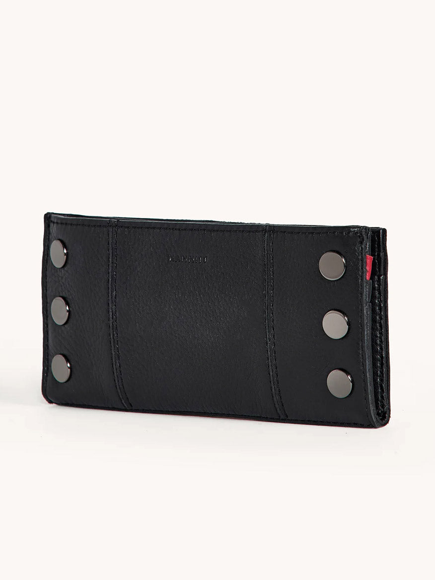 The Hammitt Los Angeles 110 North Wallet in Black/Gunmetal is a black pebble leather folding wallet featuring six gunmetal studs in two vertical rows on one side, shown upright against a plain background.