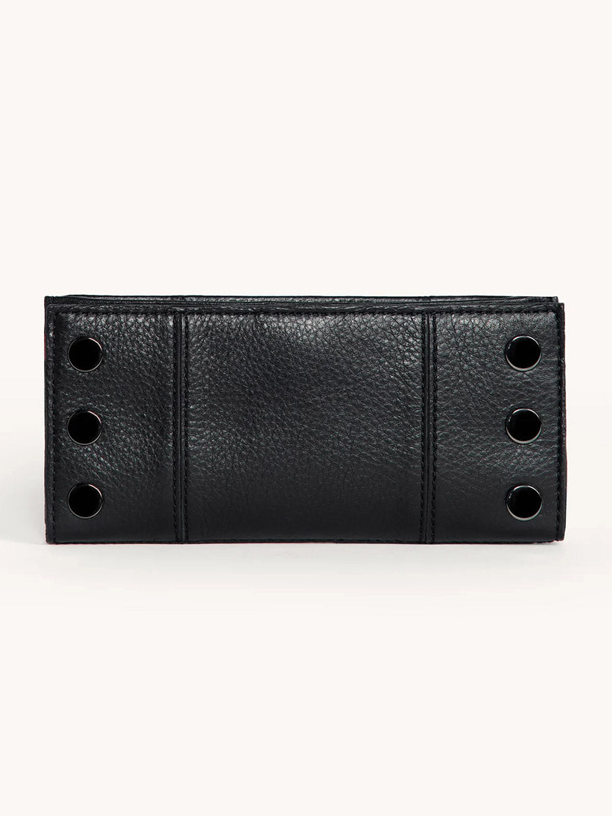 The Hammitt Los Angeles 110 North Wallet in Black/Gunmetal features black pebble leather, a textured surface, and four gunmetal grommets on each side, displayed against a plain light background.