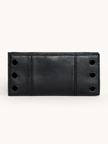 The Hammitt Los Angeles 110 North Wallet in Black/Gunmetal features black pebble leather, a textured surface, and four gunmetal grommets on each side, displayed against a plain light background.