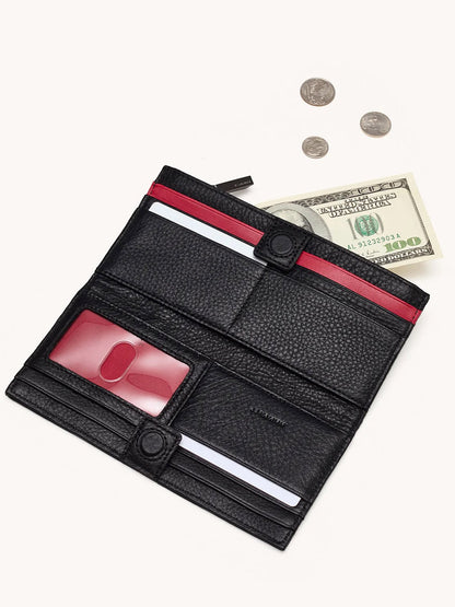 The Hammitt Los Angeles 110 North Wallet in Black/Gunmetal is open, showing credit card slots, an ID window, a hundred-dollar bill, and coins on a white surface.