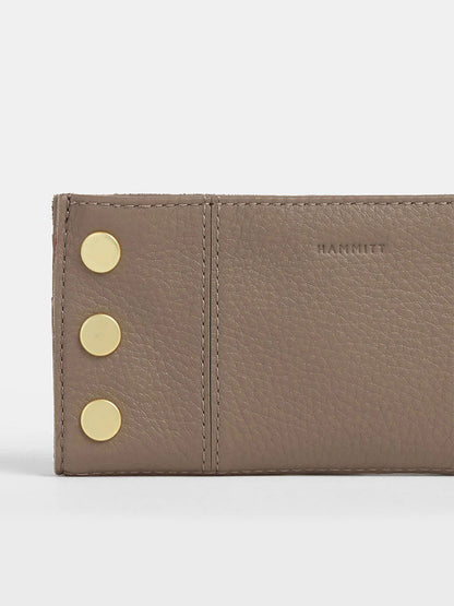 Close-up of a Sculpted Taupe Hammitt Los Angeles 110 North Wallet, showcasing its pebbled leather, three gold side buttons, multiple credit card slots, and "HAMMITT" embossed brand name.