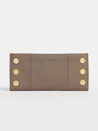 The Hammitt Los Angeles 110 North Wallet in Sculpted Taupe is a taupe pebbled leather wallet with six gold studs in two vertical rows on the front and convenient credit card slots.