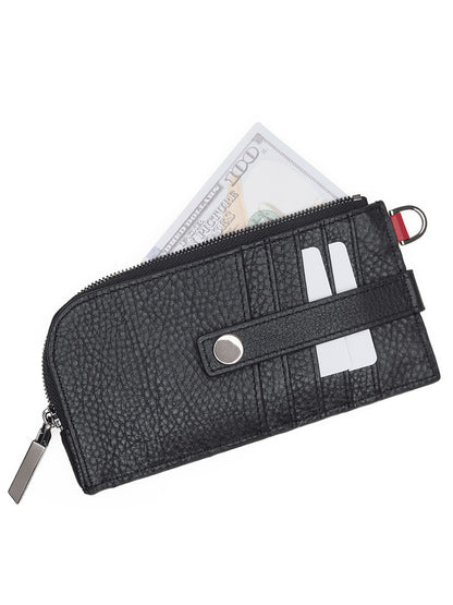 The Hammitt Los Angeles 210 East Wallet in Black/Gunmetal, crafted from black pebbled leather and featuring a zipper closure, holds two white cards and a partially visible folded hundred-dollar bill, delivering both style and functionality in a sleek card holder design.