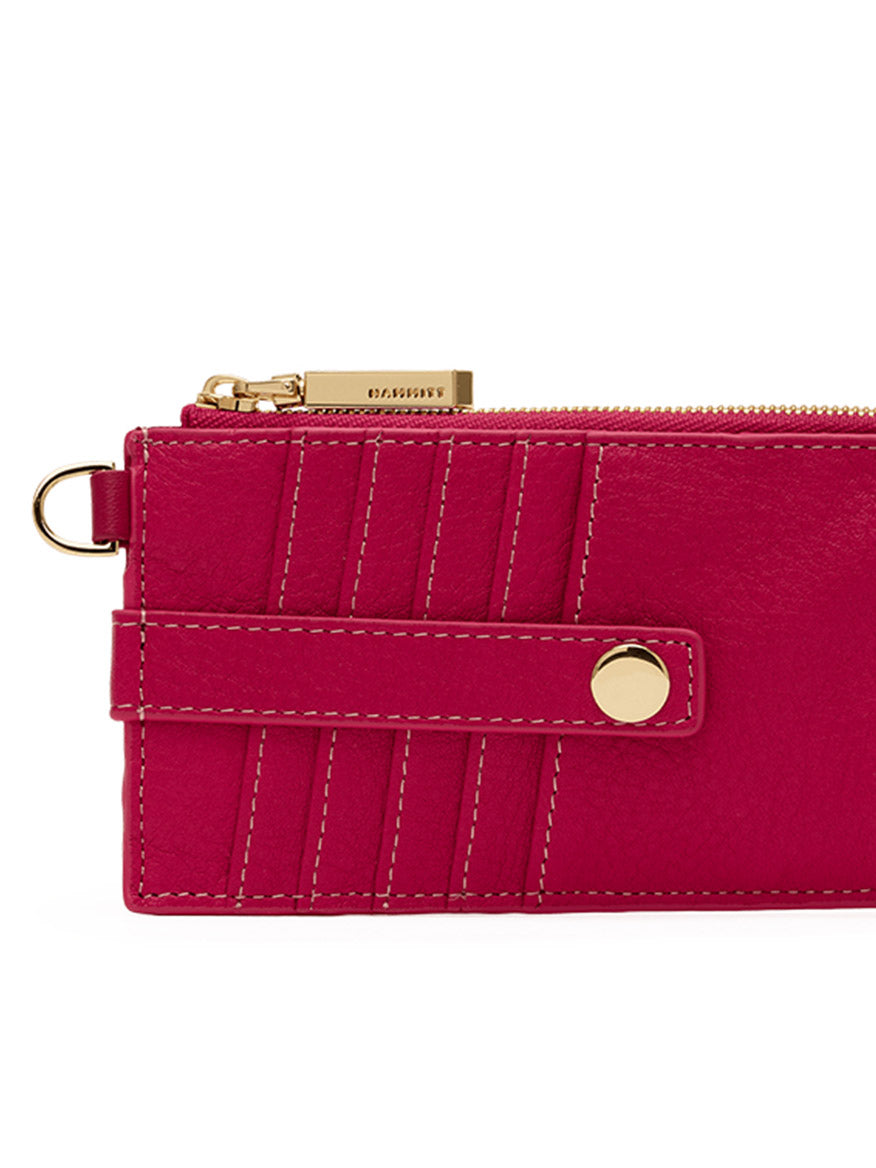 Close-up of the Hammitt Los Angeles 210 East Wallet in Calypso Pebble/Gold, a sleek women's wallet crafted from fuchsia pebbled leather, featuring a gold zipper, snap button closure, stitched detailing, and a small metal ring on the side.
