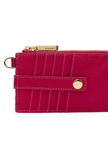 Close-up of the Hammitt Los Angeles 210 East Wallet in Calypso Pebble/Gold, a sleek women's wallet crafted from fuchsia pebbled leather, featuring a gold zipper, snap button closure, stitched detailing, and a small metal ring on the side.