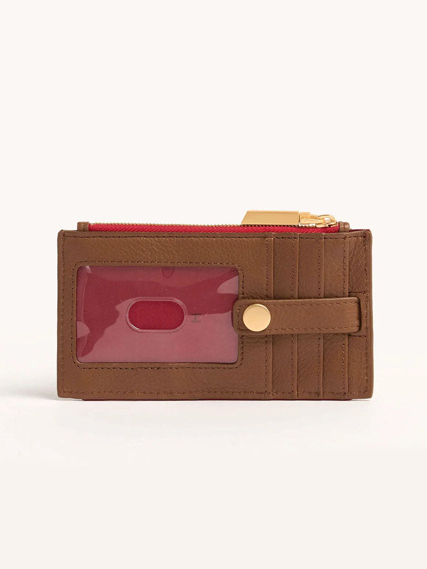 The Hammitt Los Angeles 210 West Wallet in Mahogany Pebble is a brown snap wallet made from soft pebbled leather, featuring a clear ID window, multiple card slots, a red zipper, and brushed gold hardware on the snap closure strap.