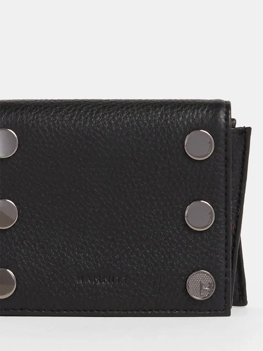 The Hammitt Los Angeles Allen Wallet in Black is designed with sleek black pebbled leather, adorned with silver button-style studs on the front, a subtle embossed logo, and a zippered main compartment to keep your essentials secure.