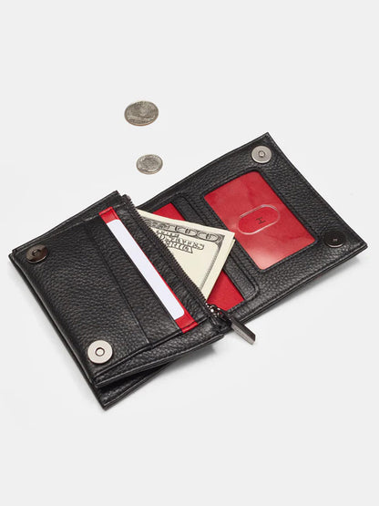 An open Hammitt Los Angeles Allen Wallet in Black, crafted from pebbled leather, reveals a striking red interior with dedicated sections for bills, cards, and an ID. Placed beside the wallet are three coins that enhance the elegance of its zippered main compartment.