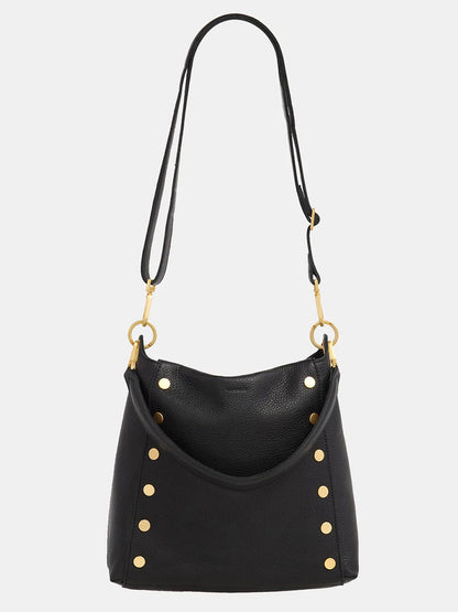 The Bryant Large Crossbody Bag by Hammitt Los Angeles features a sleek black pebbled leather design with eye-catching brushed gold studs. Its adjustable crossbody strap, accented with gold rings, allows for versatile wear.