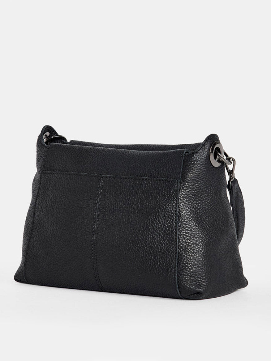 A Hammitt Los Angeles Bryant Medium Crossbody Bag in Black, featuring a pebbled leather texture, metal ring accents, and adjustable shoulder straps, viewed from the back.