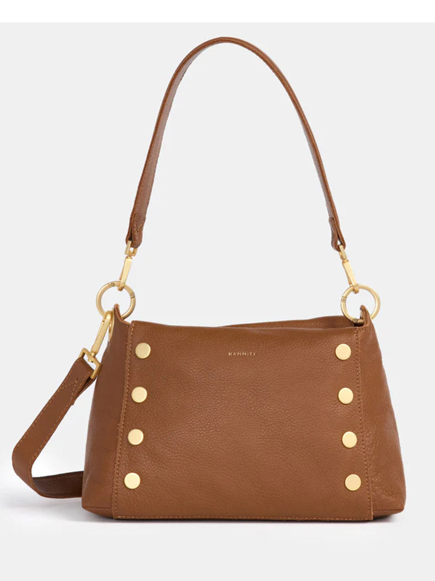 A revamped Hammitt Los Angeles Bryant Medium Crossbody Bag in Mahogany Pebble with gold-tone hardware and six circular studs on the front. It features an adjustable shoulder strap, two handle rings, and a soft pebbled texture.