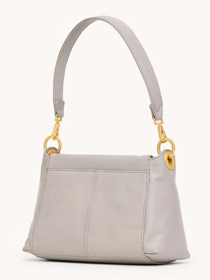 A Hammitt Los Angeles Bryant Medium Crossbody Bag in Stormy/Brushed Gold with pebble leather, a short strap, and gold-tone hardware, displayed against a plain background.