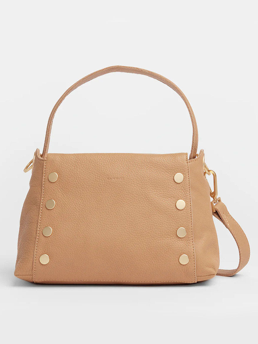 The Hammitt Los Angeles Bryant Medium Crossbody Bag in Toast Tan features a pebbled leather finish with gold studs, two handles, and adjustable straps for versatile use as a shoulder or crossbody bag.