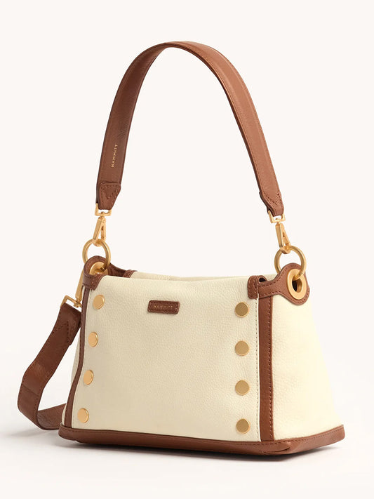 The Hammitt Los Angeles Bryant Medium Crossbody Bag in Courtyard Cream features a cream body, brown pebbled leather trim, gold-tone hardware, stud accents, and two detachable straps.