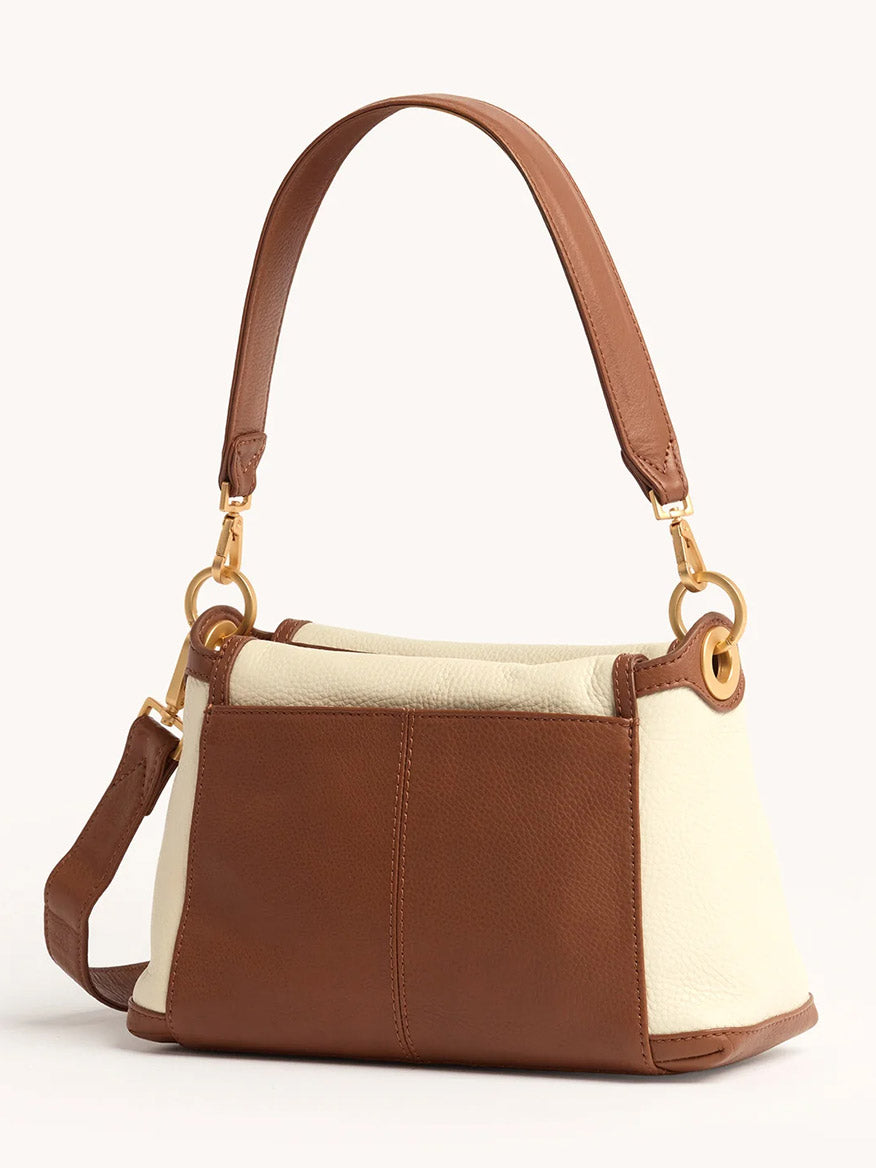 The Hammitt Los Angeles Bryant Medium Crossbody Bag in Courtyard Cream features a brown pebbled leather base, cream side panels, gold hardware, and a short handle.