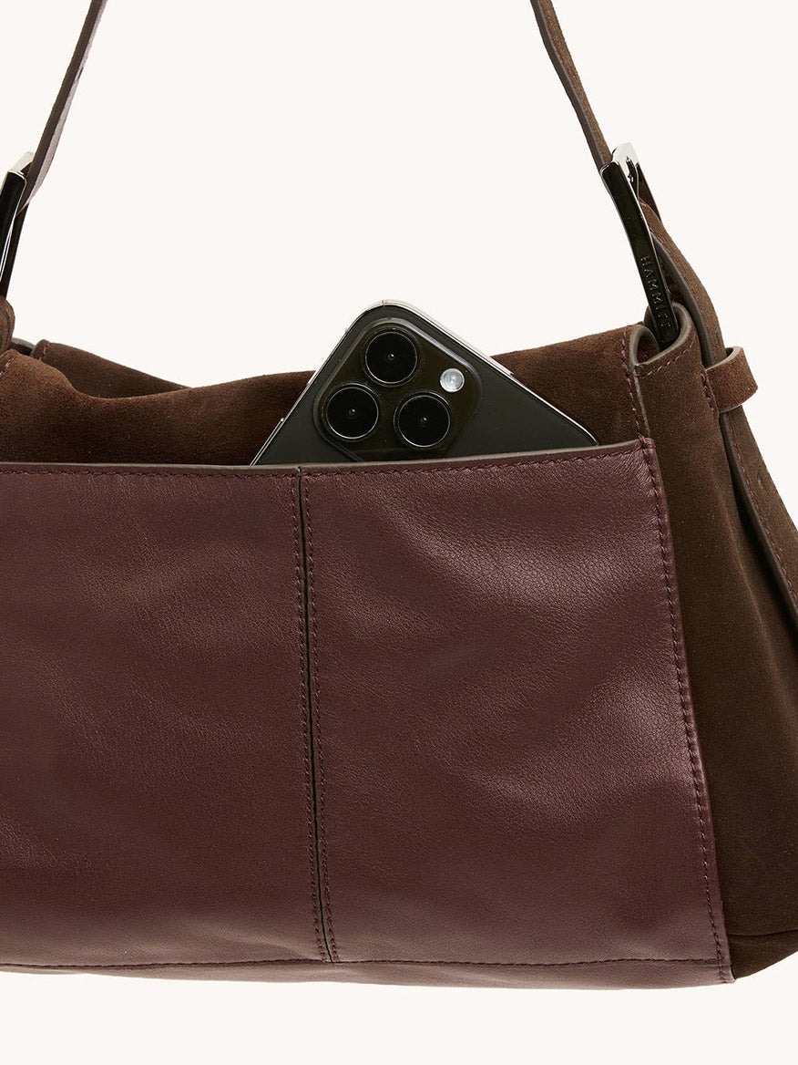 The Hammitt Los Angeles Bryant Medium Crossbody Bag in Belted Suede/Gunmetal features an exterior pocket that fits a black triple-lens smartphone.