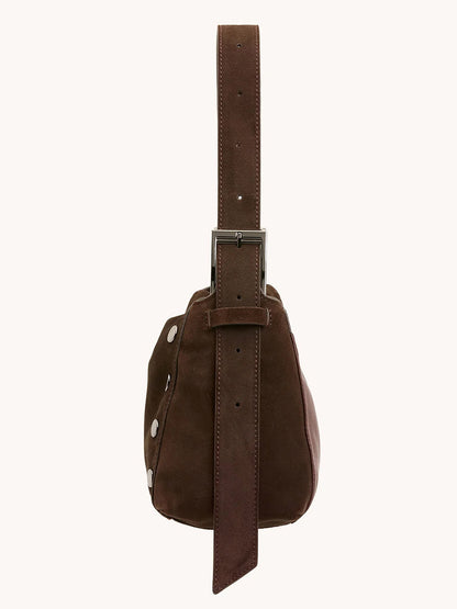 Side view of the Hammitt Los Angeles Bryant Medium Crossbody Bag in brown belted suede with gunmetal hardware, featuring silver studs and a large rectangular buckle.