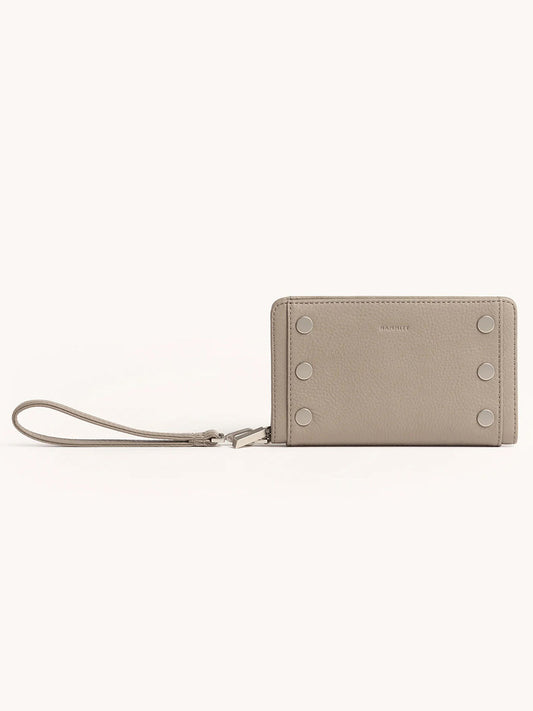 The Hammitt Los Angeles Bryant Wallet in Pewter Pebble, featuring pebbled leather, metal stud accents, and a detachable wristlet strap, is displayed against a plain background.