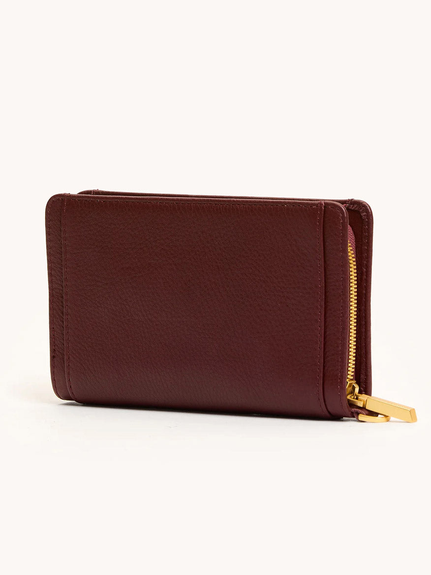 The Hammitt Los Angeles Bryant Wallet in Cherrywood Pebble/Brushed Gold, featuring a visible gold zipper, is displayed closed against a plain light background.