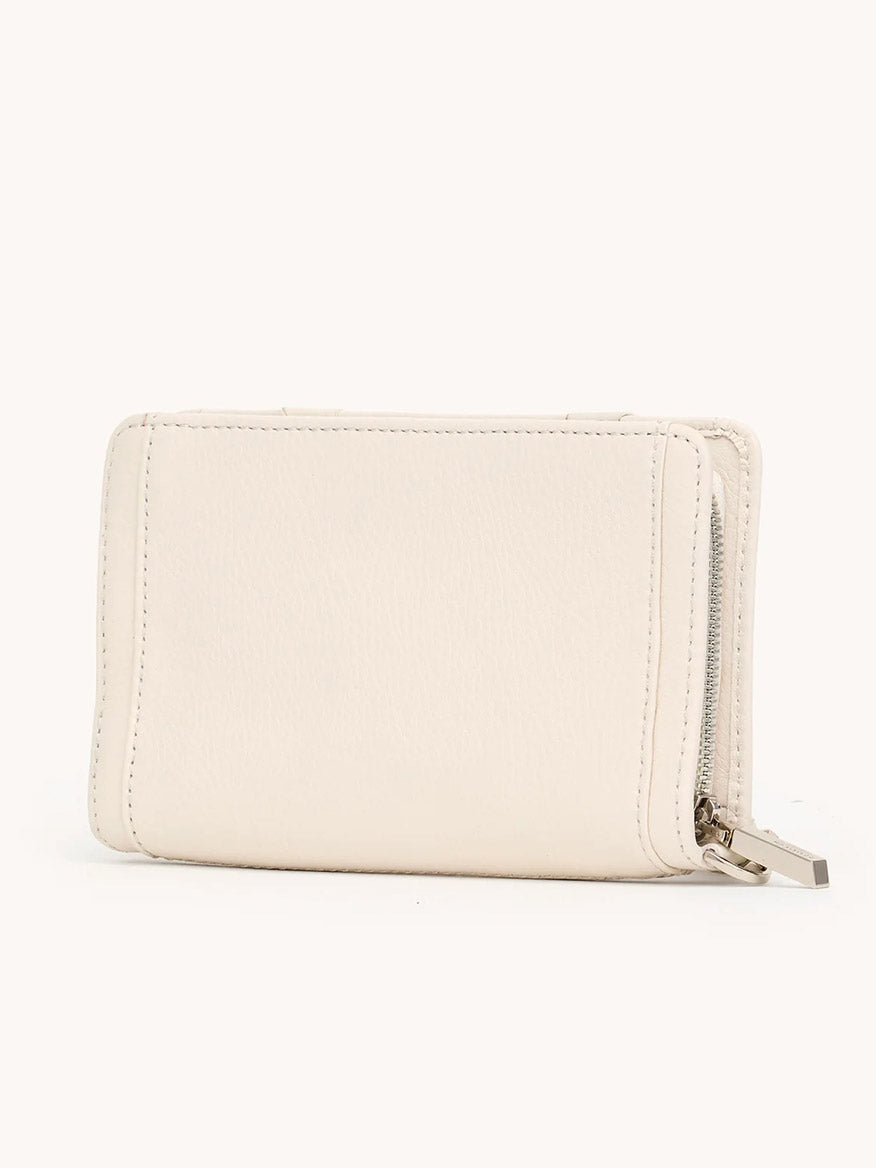 The Hammitt Los Angeles Bryant Wallet in Western Rein/Silver is a compact rectangular pebble leather wallet in light beige, featuring visible stitching and a metal zipper on the right side, photographed against a plain background.