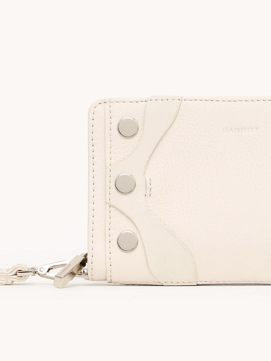 A close-up of the Hammitt Los Angeles Bryant Wallet in Western Rein/Silver, crafted from pebble leather with three metal snap buttons and a keychain attachment on the left side.