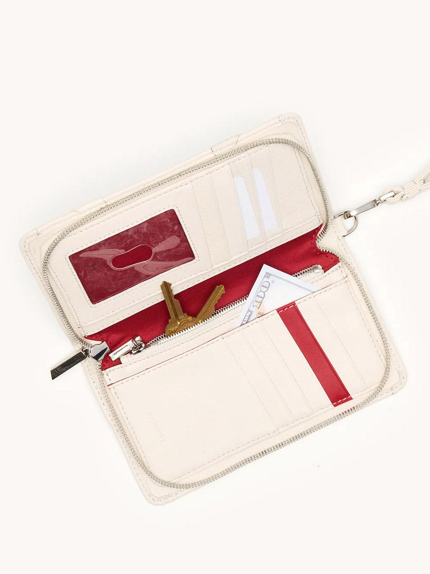 The Hammitt Los Angeles Bryant Wallet in Western Rein/Silver is shown open, revealing card slots, a clear ID window, keys, cash, and cards inside; includes a detachable wristlet for versatile carrying.