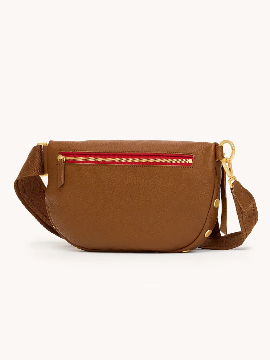 The Hammitt Los Angeles Charles Crossbody Large in Mahogany Pebble features brushed gold hardware, a red zipper accent, adjustable strap, and pebbled leather—all set against a plain background.