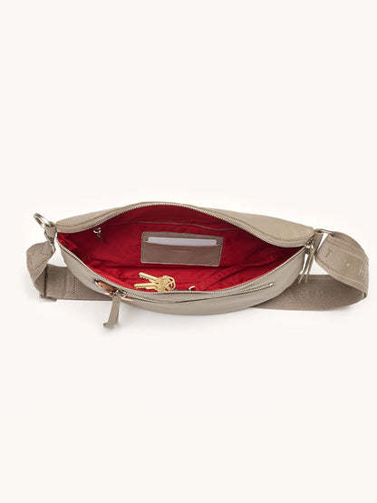 The Hammitt Los Angeles Charles Crossbody Large in Pewter Pebble/Brushed Silver is a leather bag with red lining and a roomy zippered compartment that fits your wallet and keys.