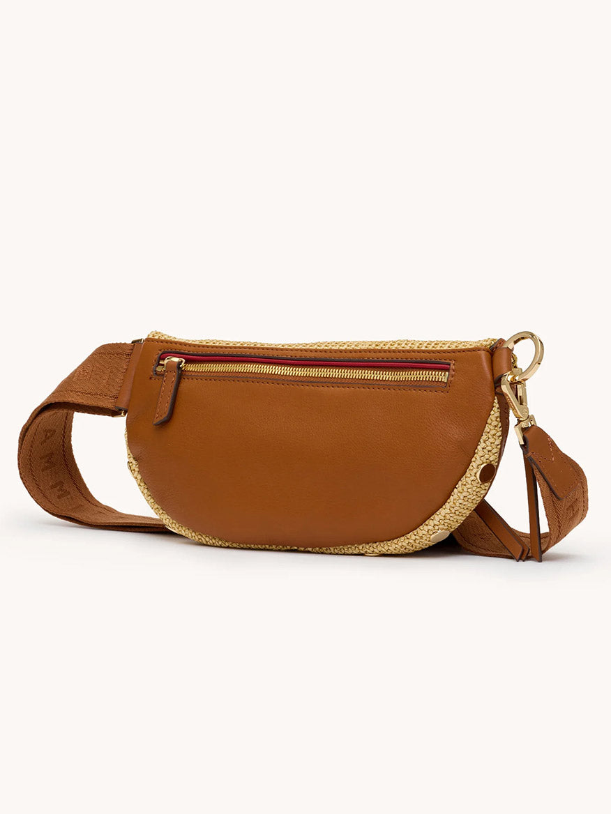 The Hammitt Los Angeles Charles Crossbody Medium in Cocoa Raffia/Gold features brown pebbled leather, woven straw, a zippered front pocket, and an adjustable strap, shown against a plain light background.