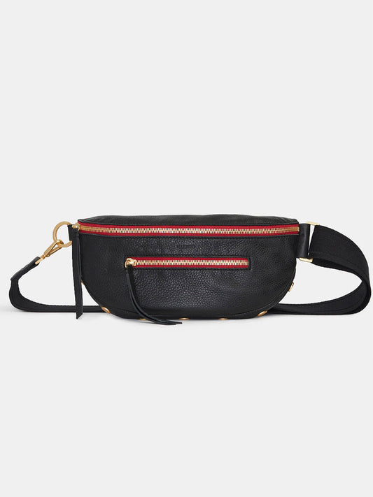 The Hammitt Los Angeles Charles Crossbody Medium in Black/Brushed Gold/Red Zip is an elegant belt bag crafted in pebbled black leather, highlighted by a bold red zipper and gold hardware. It features a front zippered pocket and offers an adjustable strap for versatile use.