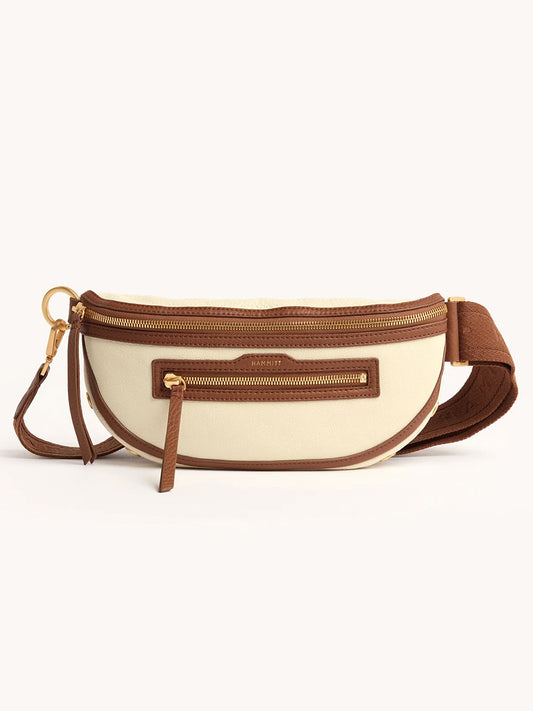 The Hammitt Los Angeles Charles Crossbody Medium in Courtyard Cream features cream and brown pebbled leather, gold zipper and hardware, adjustable strap, and a front zip pocket.