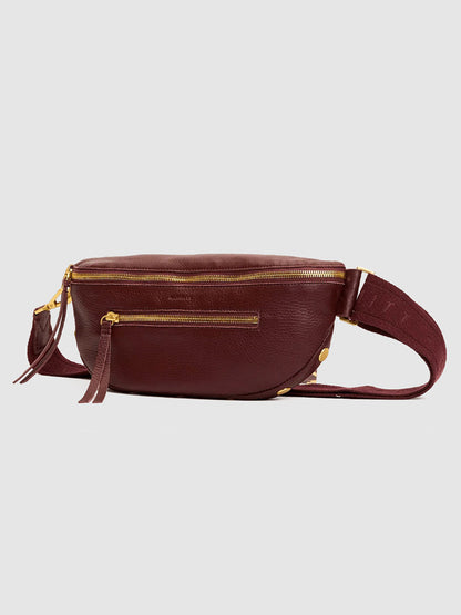 The Hammitt Los Angeles Charles Crossbody Medium in Cherrywood Pebble/Brushed Gold, featuring gold zippers and a wide adjustable strap, is displayed against a plain light gray background.