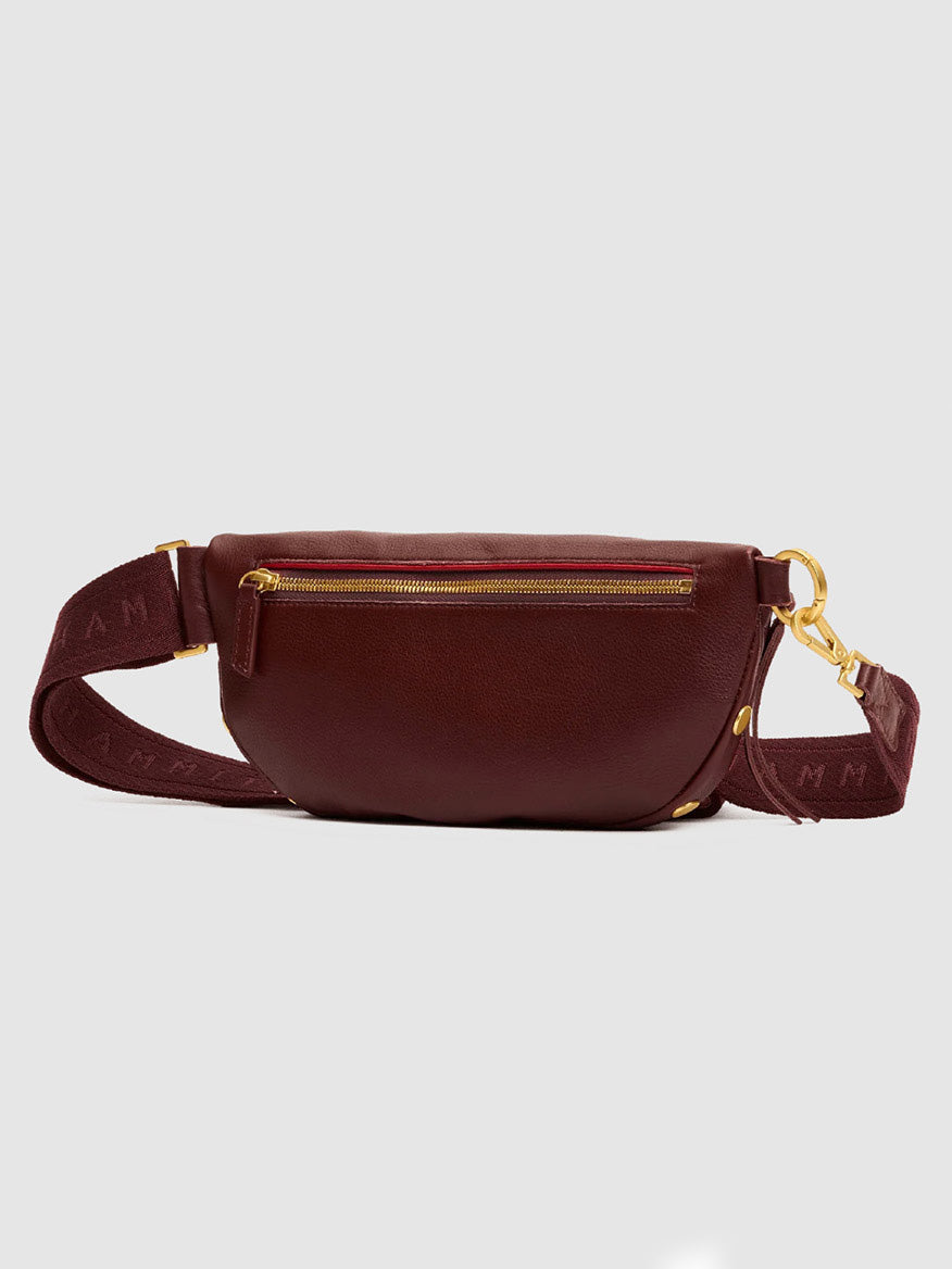 Hammitt Los Angeles Charles Crossbody Medium in Cherrywood Pebble/Brushed Gold, featuring pebble leather in a maroon hue, brushed gold zipper and hardware, and an adjustable strap with subtle text.