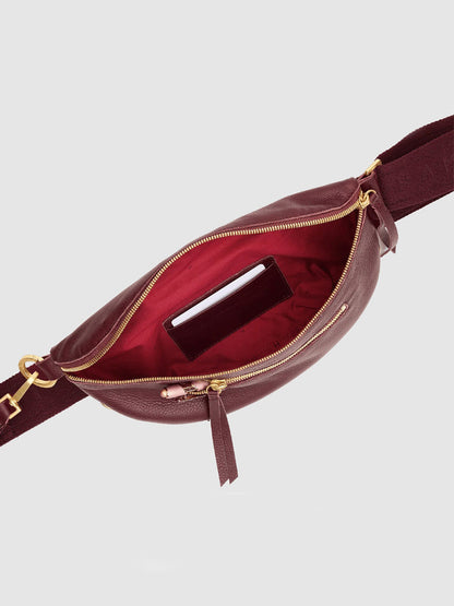 The Hammitt Los Angeles Charles Crossbody Medium in Cherrywood Pebble/Brushed Gold features a burgundy pebble leather exterior with a brushed gold zipper, shown open to reveal its vibrant red interior and a small card tucked into the inside pocket.