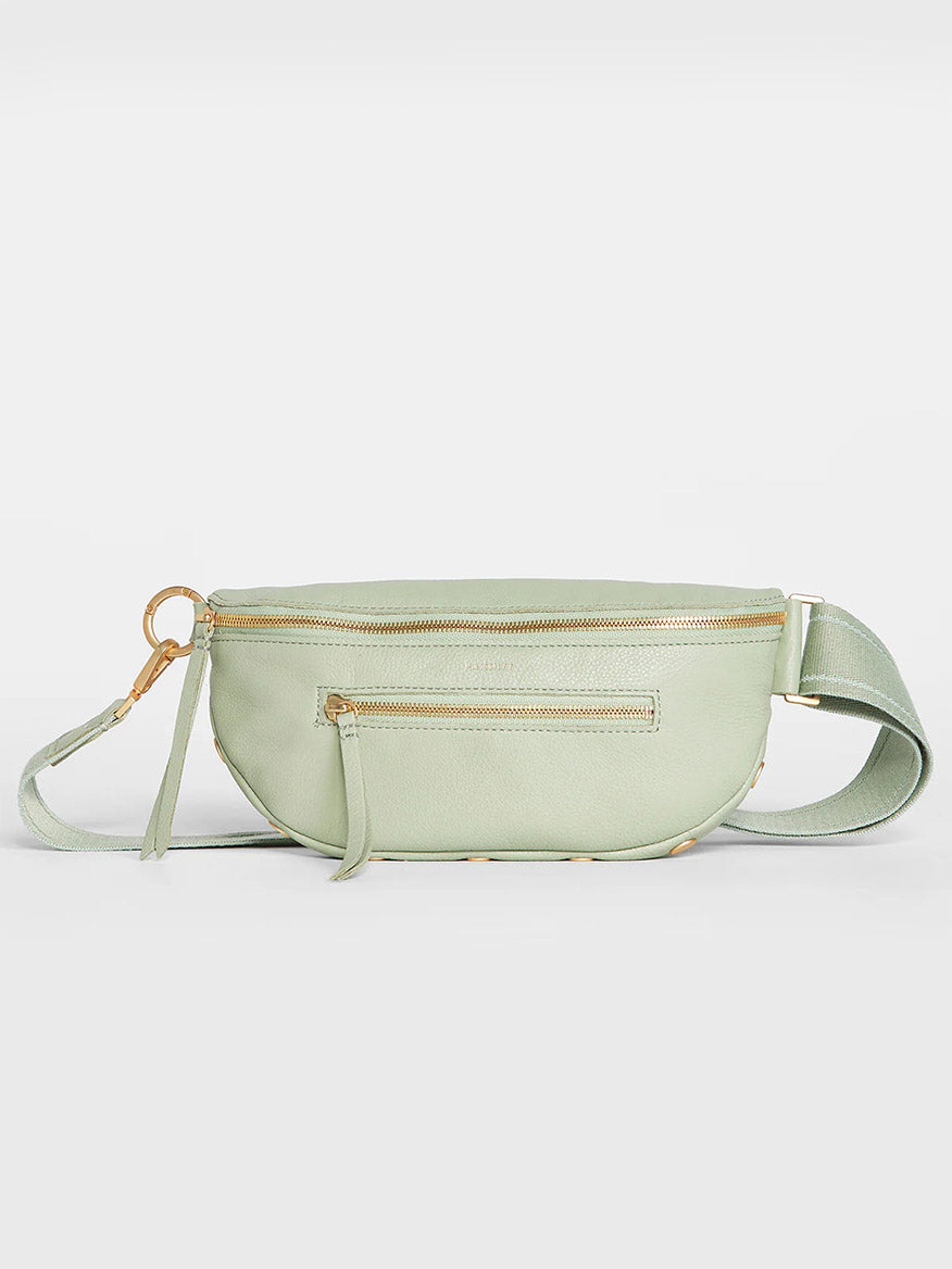 A Hammitt Los Angeles Charles Crossbody Medium in Cypress Sage with multiple zippers, displayed against a neutral background.