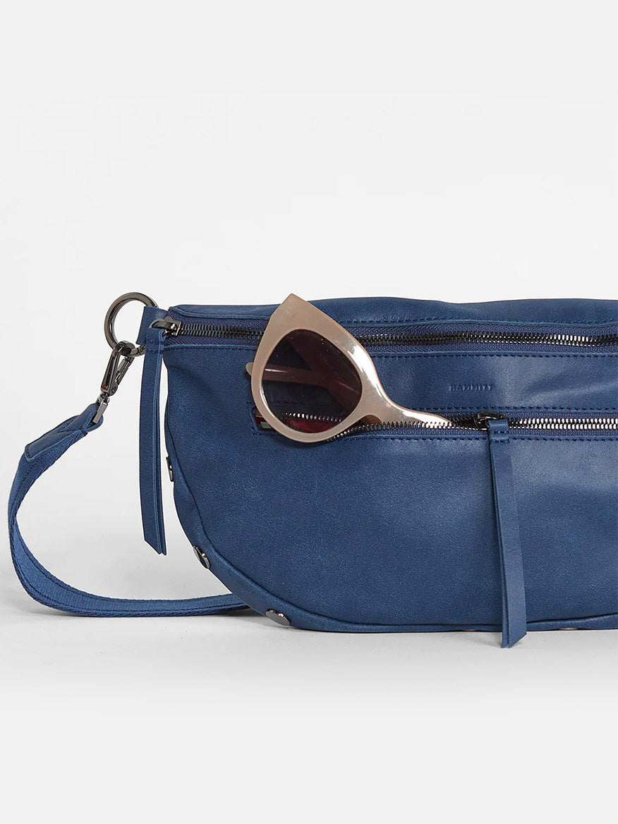 Hammitt Los Angeles Charles Crossbody Large in Vintage Navy fanny pack with a pair of sunglasses resting on top against a plain white background.