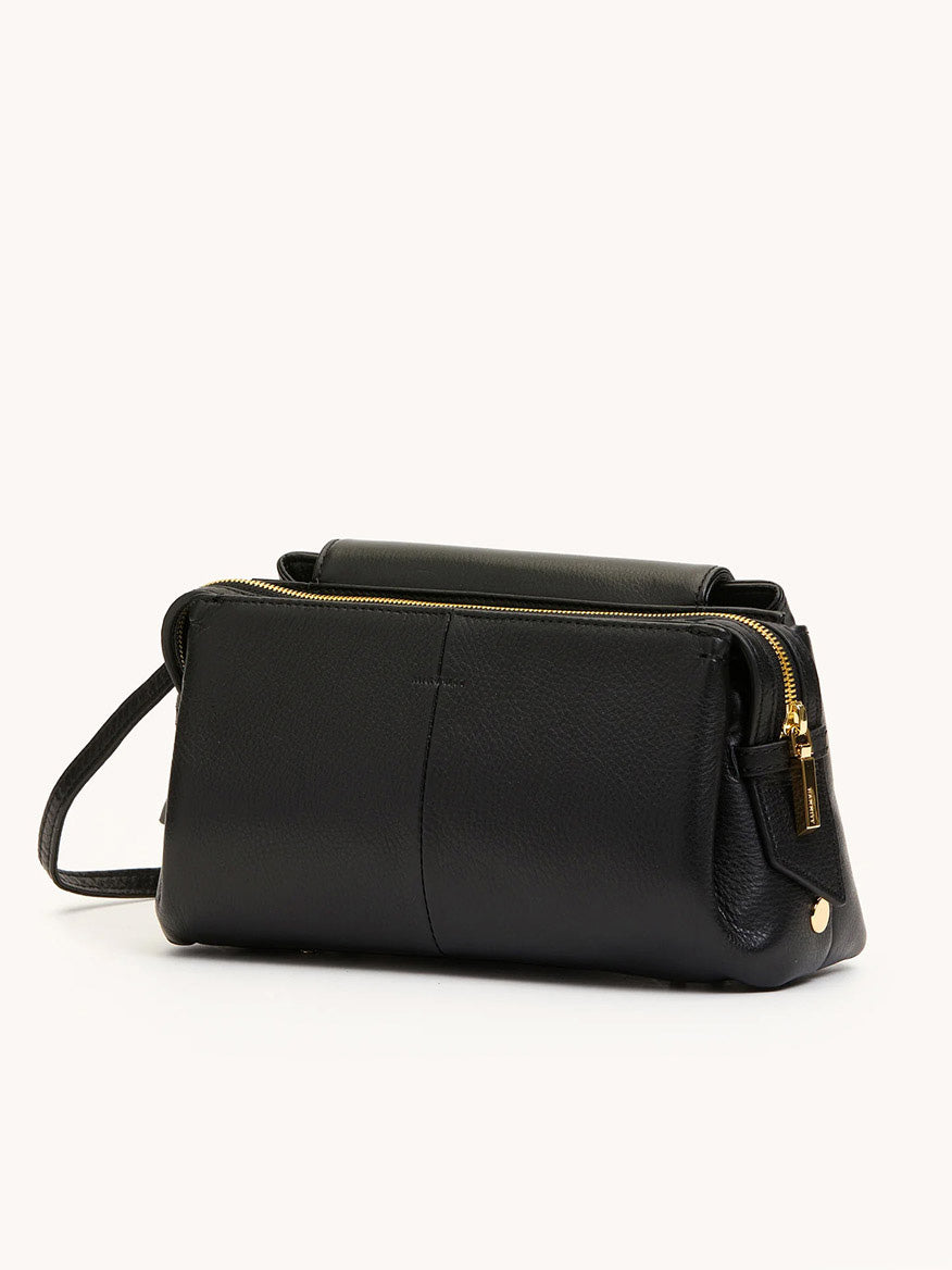 The Hammitt Los Angeles Charlotte Medium in Black/Gold is a black pebble leather crossbody with gold zippers and hardware, a structured rectangular shape, long strap, and spacious capacity for your essentials.