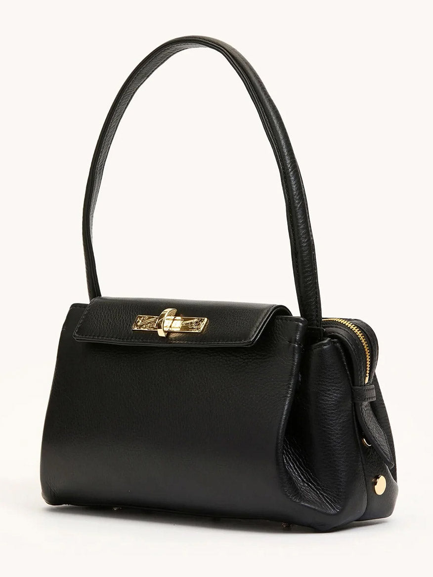 The Hammitt Los Angeles Charlotte Medium in Black/Brushed Gold is a structured black pebble leather bag with gold-tone hardware, a top handle, turn-lock flap closure, and spacious interior for all your essentials.