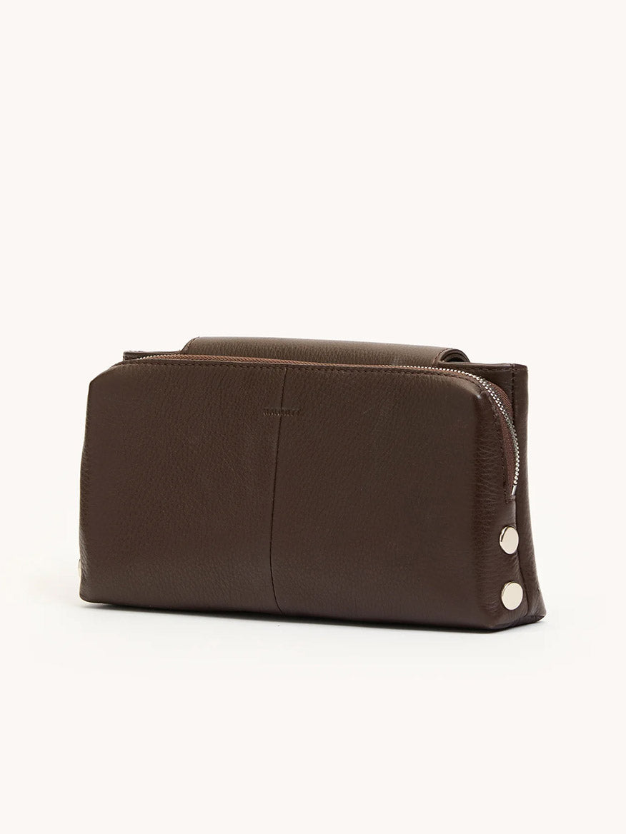 The Hammitt Los Angeles Charlotte Small in Espresso Pebble/Silver is a brown leather zippered pouch with three silver snaps—ideal as an evening clutch or stylish crossbody bag.