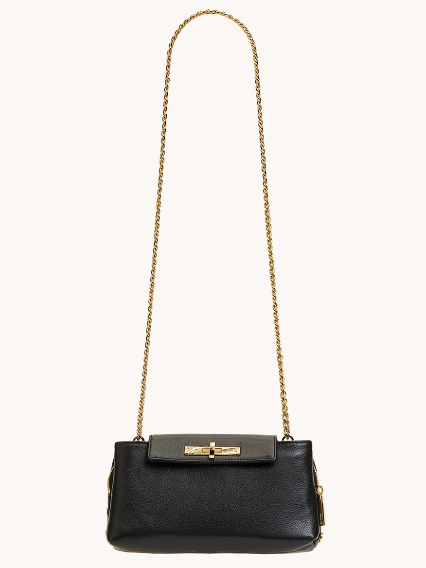 The Hammitt Los Angeles Charlotte Small in Black/Gold is a black pebble leather crossbody bag with a gold chain strap, gold clasp, and a gray flap closure at the top.