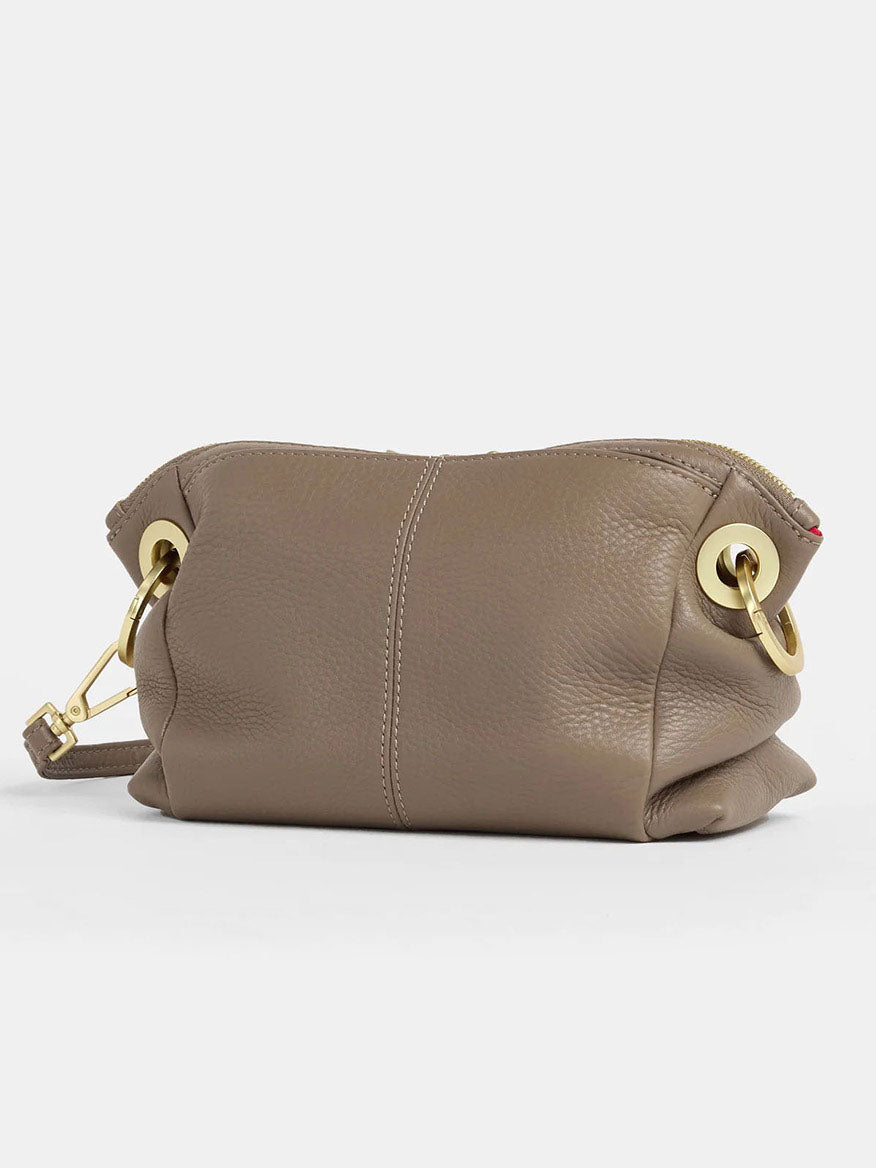 This Daniel crossbody clutch from the Hammitt Los Angeles Sculpted Taupe collection merges elegance and versatility with brown pebbled leather, gold accents, a zip closure, and a detachable strap for stylish functionality.