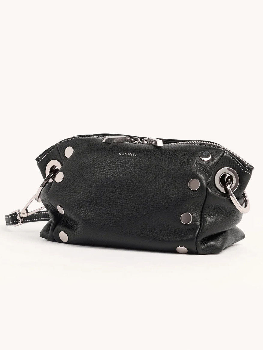 The Hammitt Los Angeles Daniel Crossbody Clutch Small in Tempo Black boasts luxurious black pebbled leather, elegant silver grommet accents, a secure zip closure, and a versatile crossbody strap.