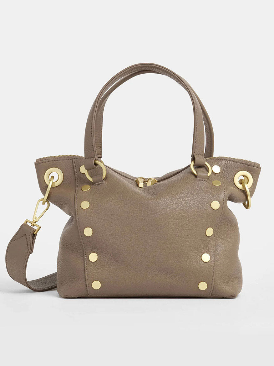 The Hammitt Los Angeles Daniel Medium Satchel in Sculpted Taupe is a compact satchel made of taupe pebbled leather, highlighted with brushed gold studs and hardware. It includes two handles and an adjustable shoulder strap.