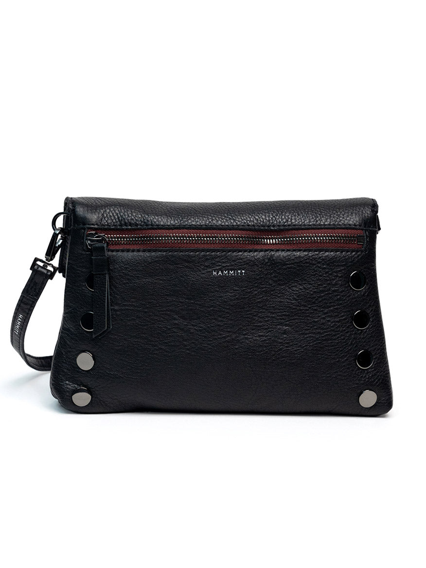 The Hammitt Los Angeles Dillon Small in Midnight Marquise/Gunmetal is a sleek black leather convertible clutch with a front zipper pocket, silver rivet details, and a detachable wrist strap.
