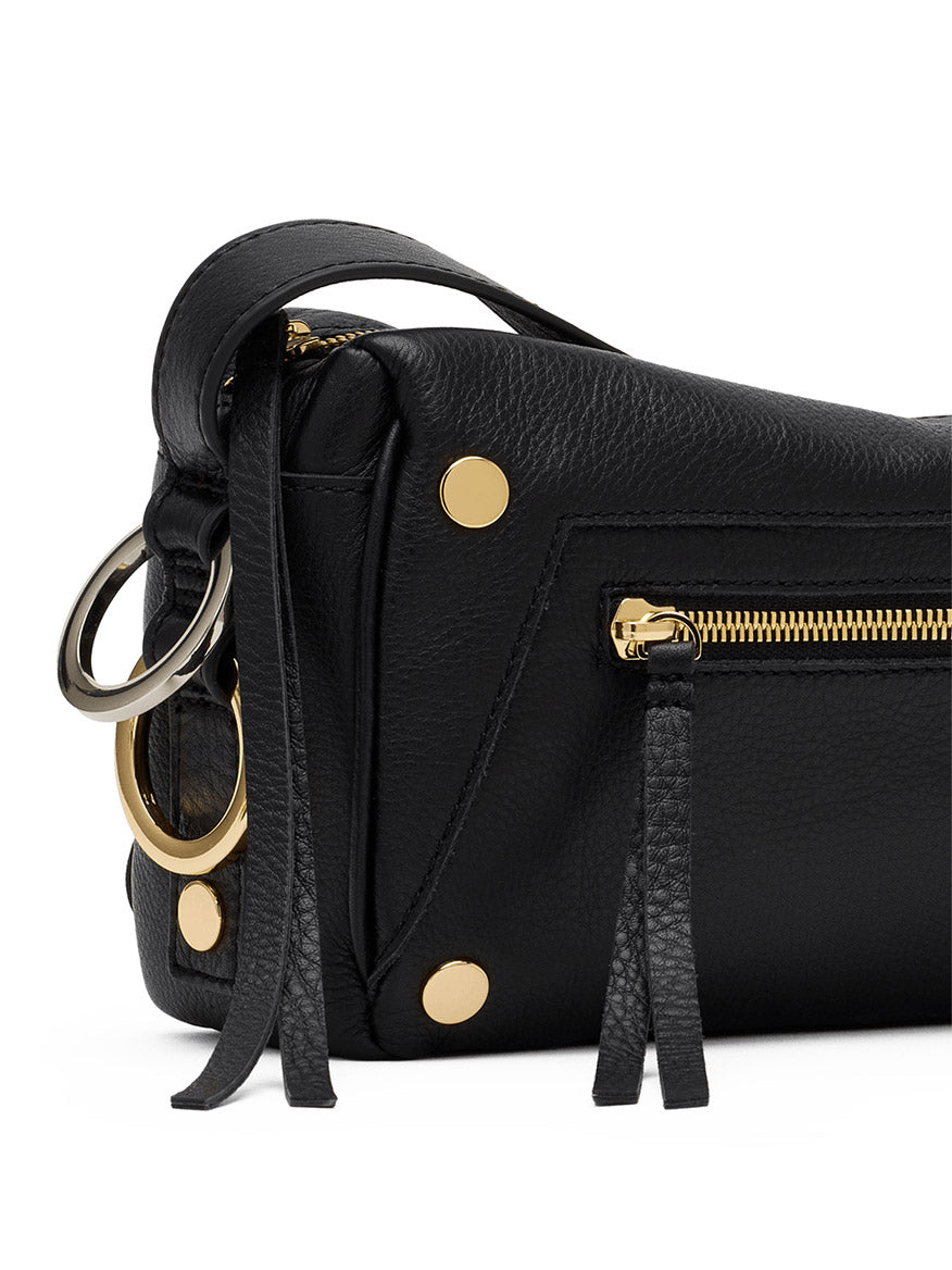 Close-up of the Hammitt Los Angeles Doxie Medium in Black/Gold/Silver—crafted from black pebbled leather with mixed gold and silver hardware, metal rings, a zippered pocket, and decorative leather tassels. The relaxed East-West silhouette adds effortless style to this elegant accessory.