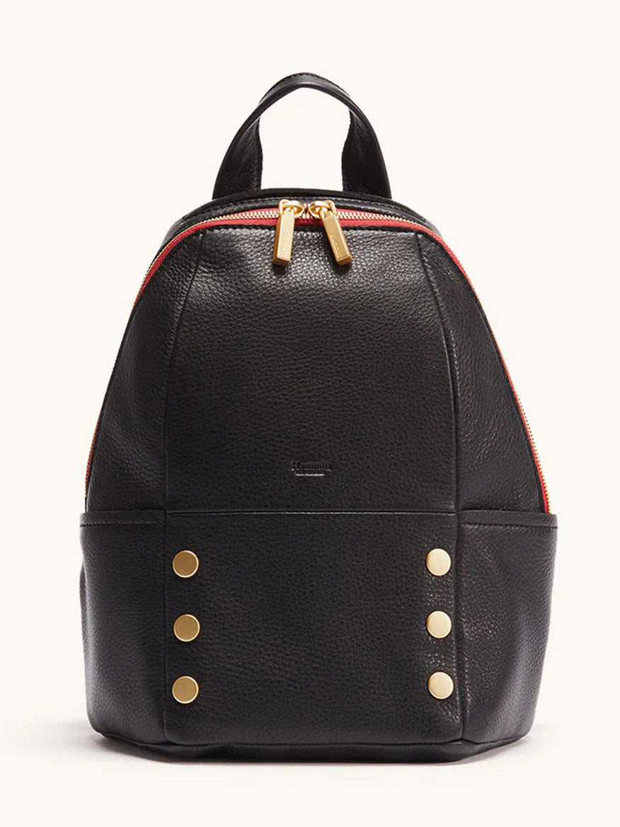 The Hammitt Los Angeles Hunter Medium Backpack in Black/Brushed Gold/Red Zip features black leather, a red zipper, gold hardware, and four gold studs on each lower front side—a stylish travel accessory shown against a plain light background.
