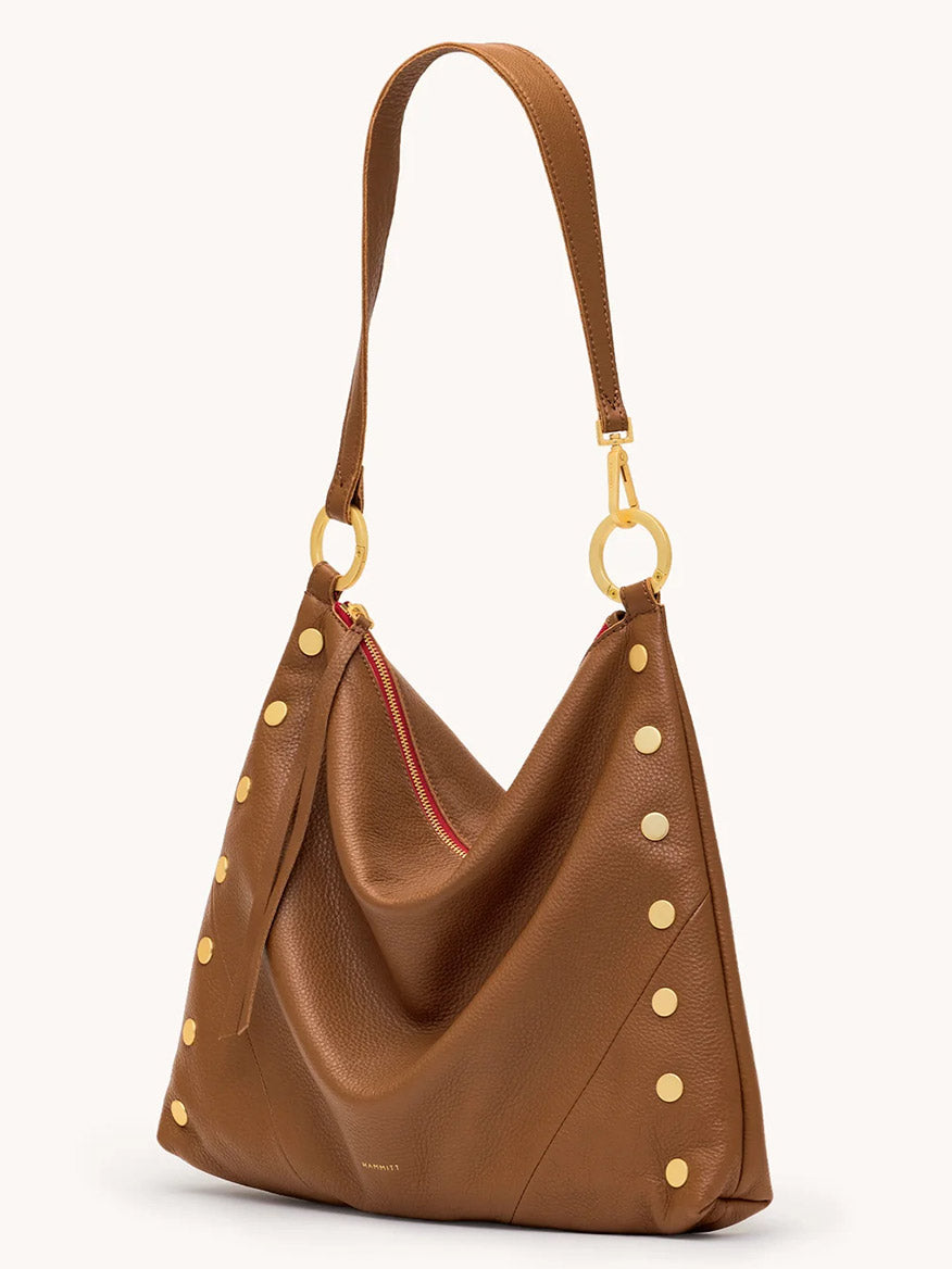 The Hammitt Los Angeles Kyle Large Shoulder Bag features mahogany pebble leather with brushed gold hardware, gold-tone studs, a single strap, and a signature red zipper detail.