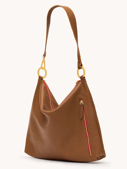 The Hammitt Los Angeles Kyle Large Shoulder Bag in Mahogany Pebble features brushed gold hardware, a single strap, and a red-accented zipper pocket for a stylish and functional look.