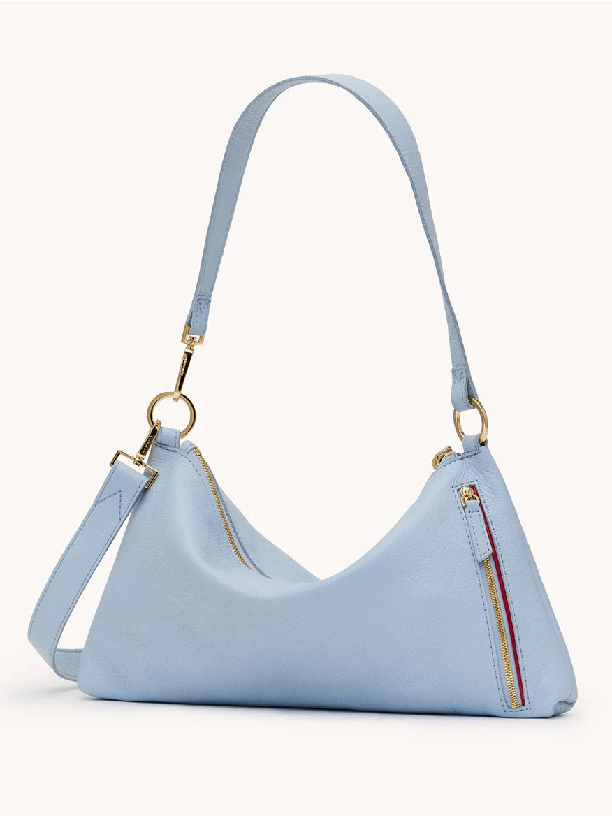 The Hammitt Los Angeles Kyle Medium Shoulder Bag in Hazy Blue/Gold features pebbled leather, gold hardware, an adjustable strap, and zipper accents on the front and top for a stylish look.